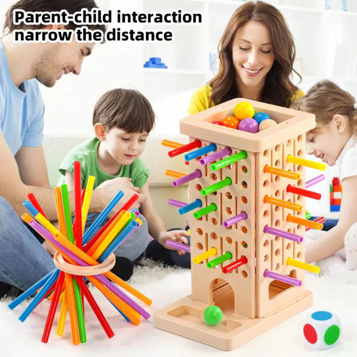 Family playing with a stick-pulling tower and a colorful bundle of sticks held by a ring