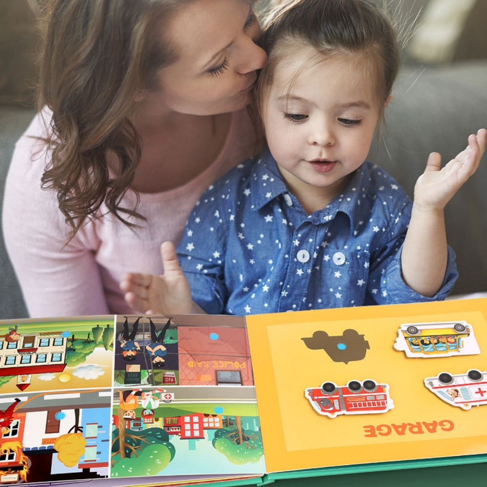 Adult and child exploring a transport-themed learning book with vehicle matching pieces
