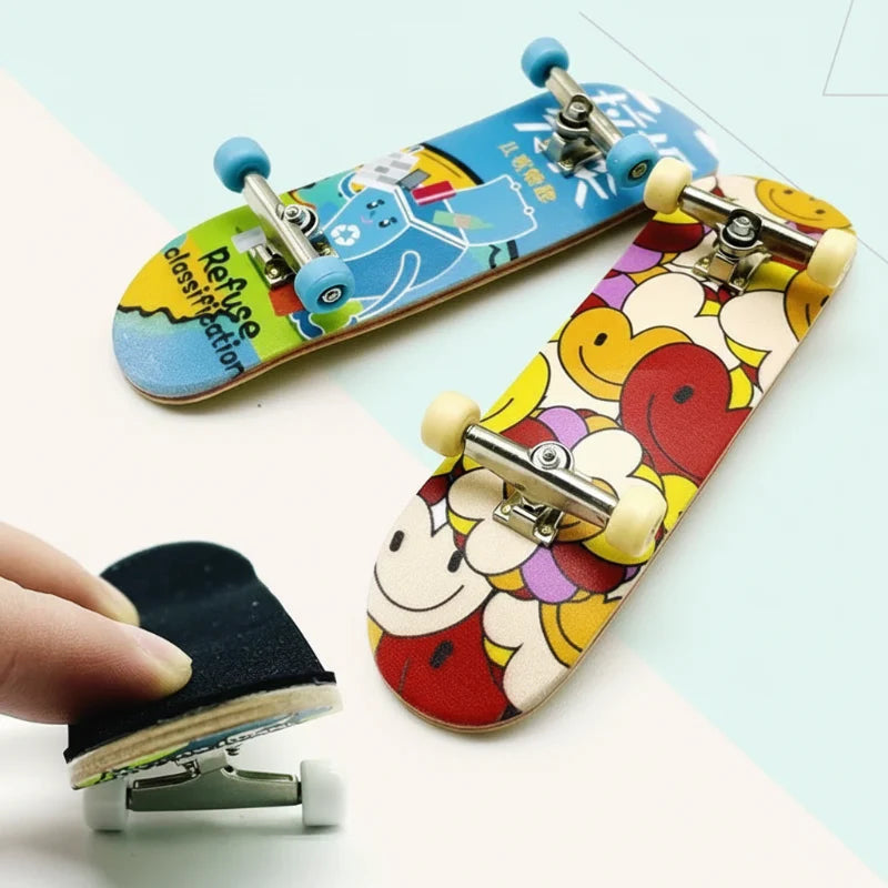 Two graphic finger skateboards with metal trucks and a close-up of the black grip pad.