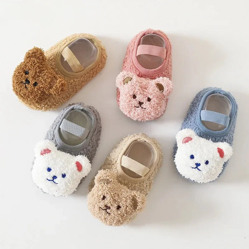 Five bear-face baby slippers in khaki, pink, gray, beige, and blue