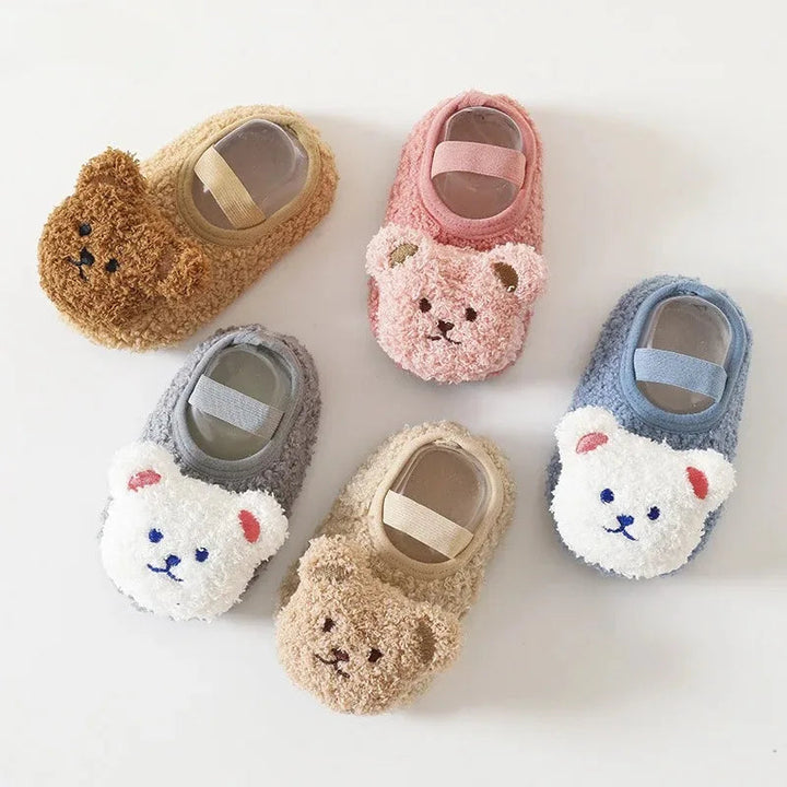 Five bear-face baby slippers in khaki, pink, gray, beige, and blue