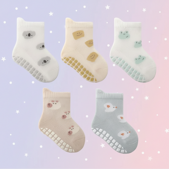 Five baby sock designs with koala, smiley, frog, bear, and bird patterns and dotted soles.