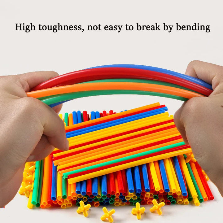 Hands bending a bundle of colorful construction tubes above loose tubes and yellow connectors