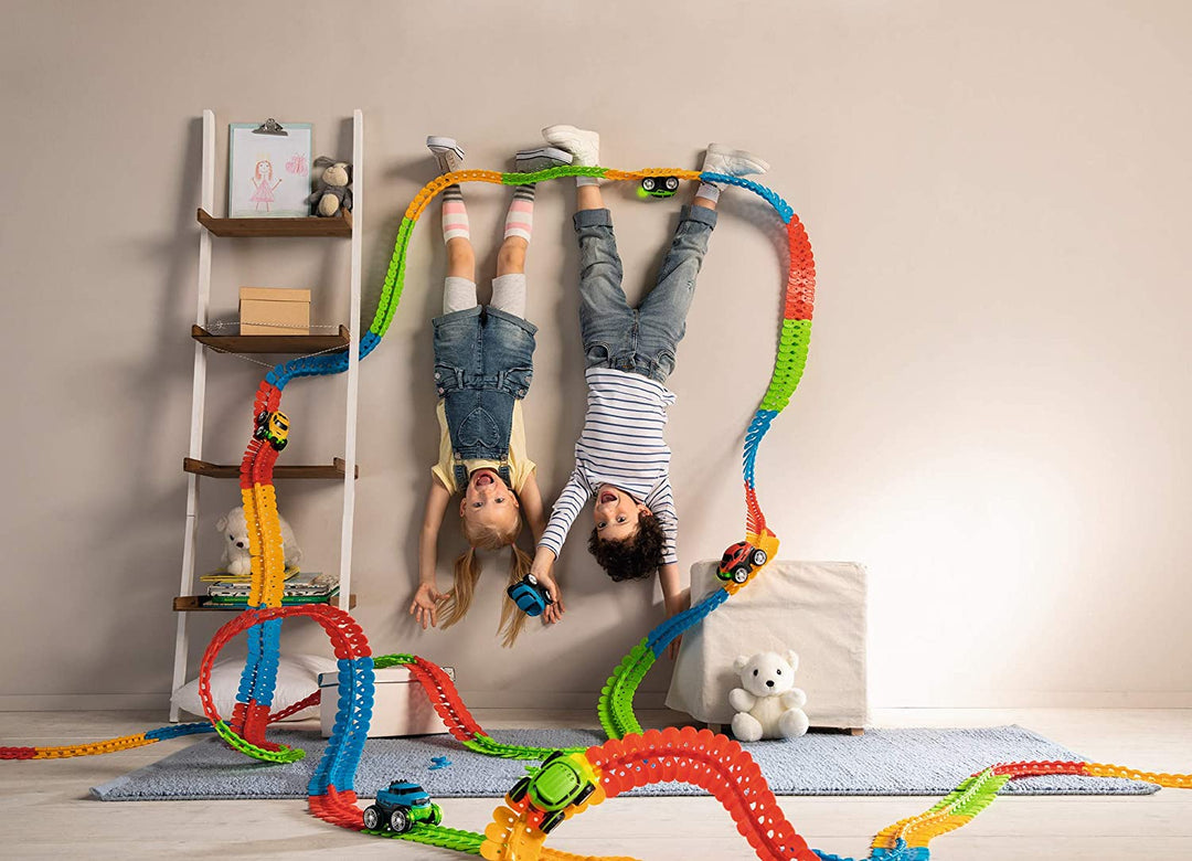 Multicolor flexible race track arranged around a ladder and bedroom furniture
