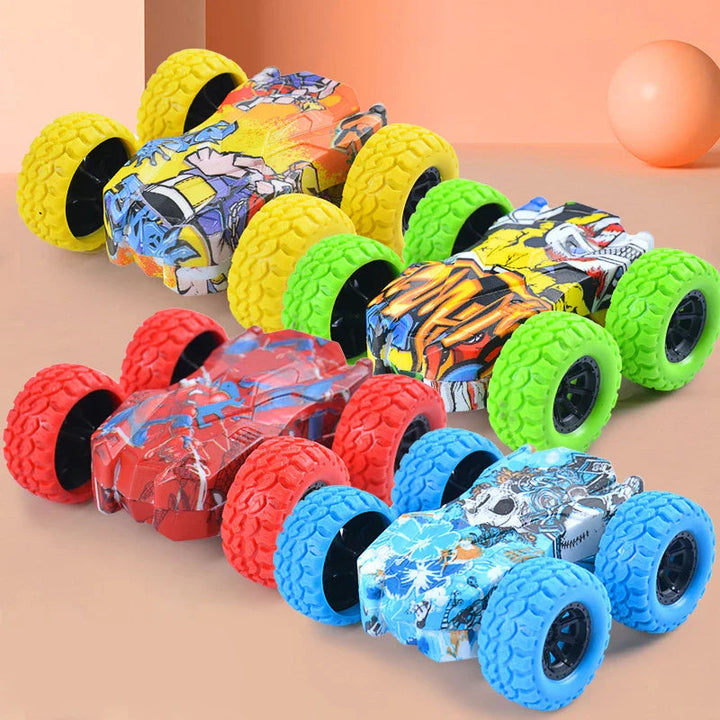 Four inertia toy cars with graphic bodies and yellow, green, red, and blue textured wheels.
