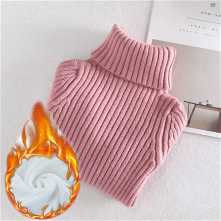 Folded pink ribbed turtleneck sweater beside an illustrated warmth graphic