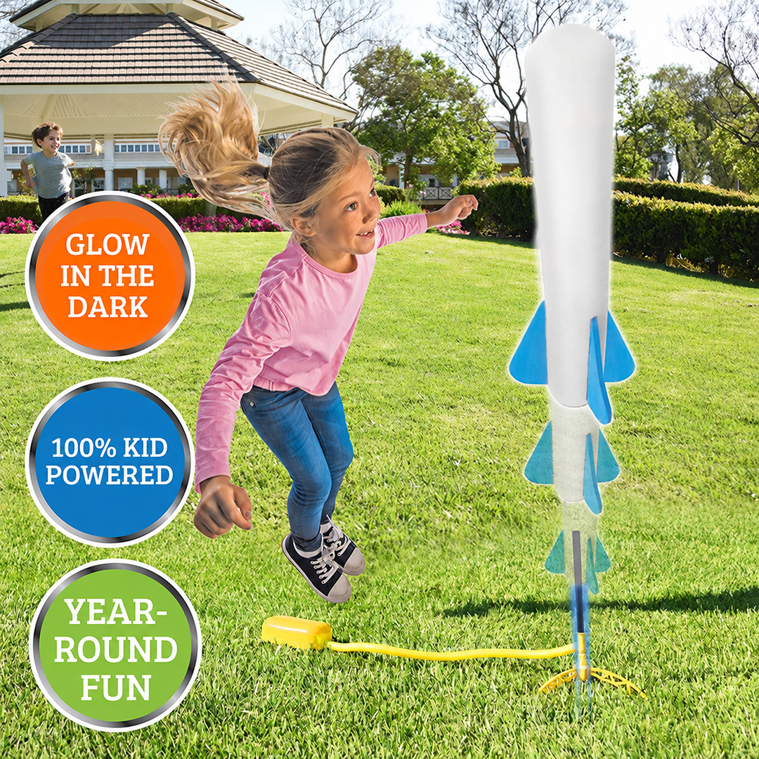 Child jumping beside a foot-powered rocket launcher on a lawn.