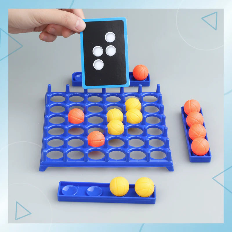 Four-dot challenge card held above the grid with yellow and orange balls