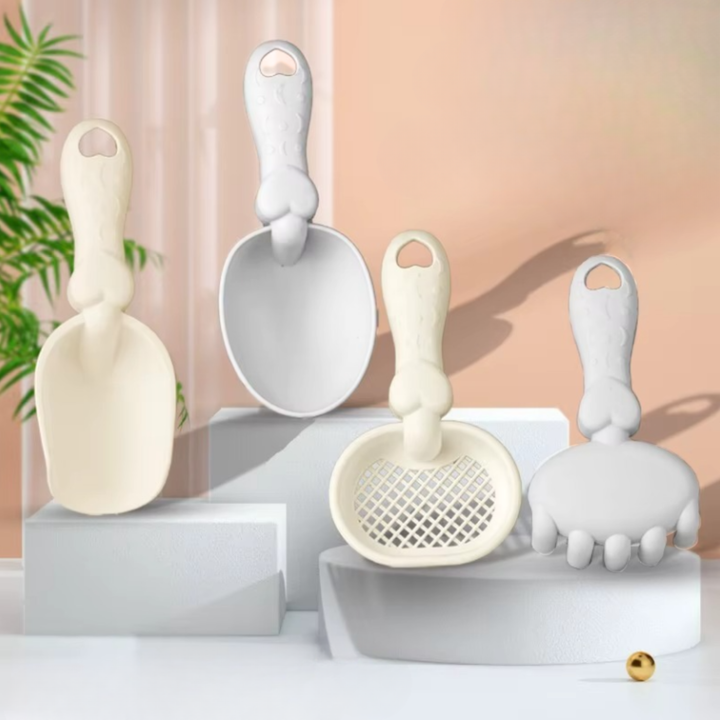 Four beach hand tools in cream and light gray: shovel, scoop, sieve, and rake