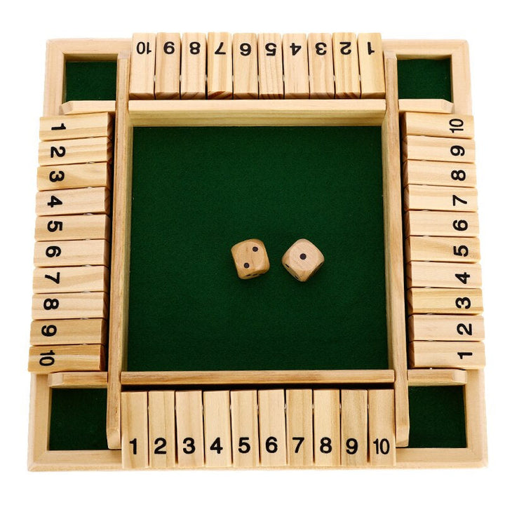 Top view of the four-sided wooden board with flaps numbered 1 to 10 and two dice