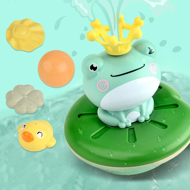Smiling frog fountain on a green lily-pad base with a yellow crown and colorful toppers
