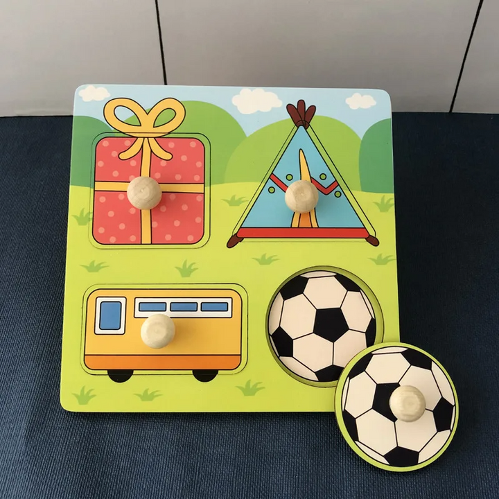 Gift-themed wooden peg puzzle showing a present, tent, camper, and soccer ball