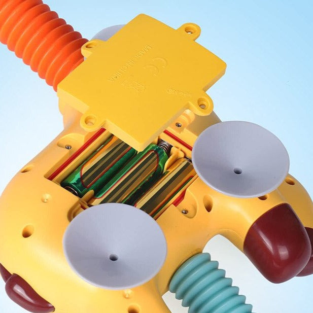 Rear view of the giraffe bath toy with an open battery compartment and suction cups
