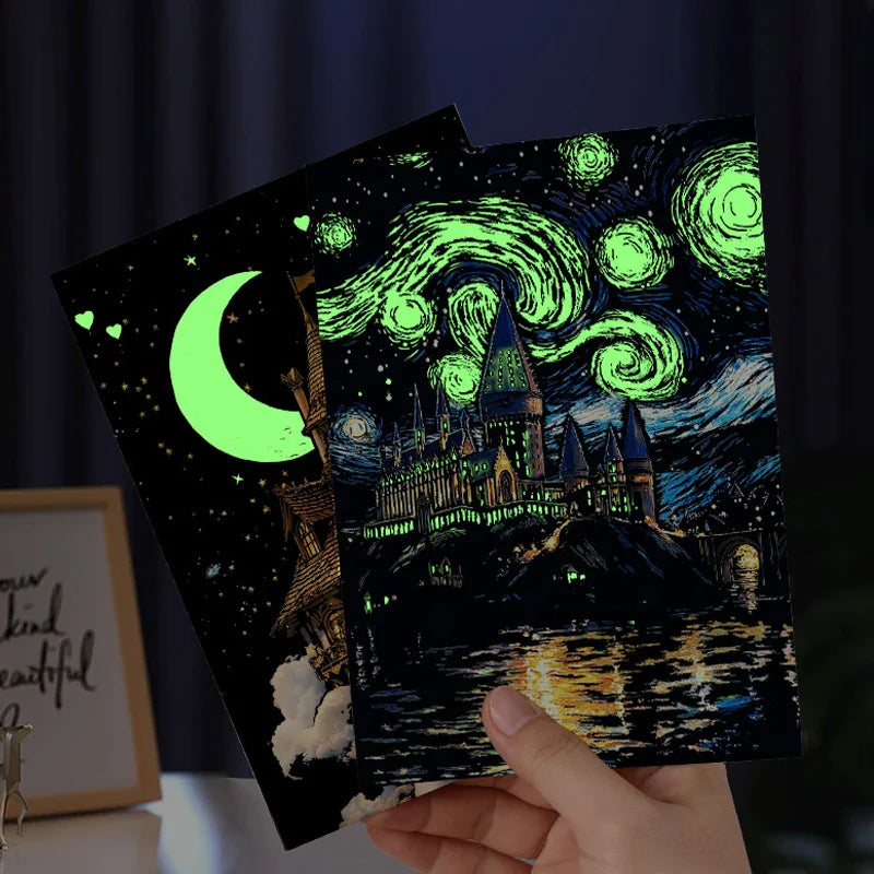 Hands holding finished moon and castle scratch cards with glowing green details