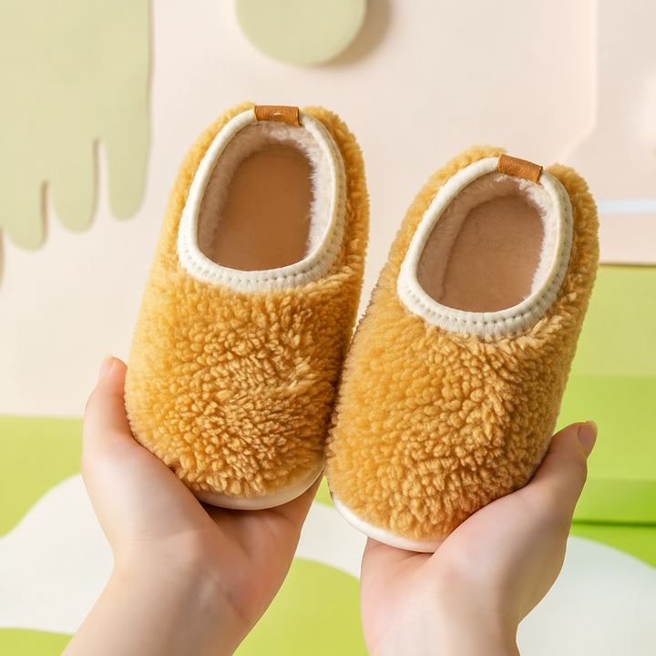 Golden yellow textured slippers with cream-colored openings, held side by side