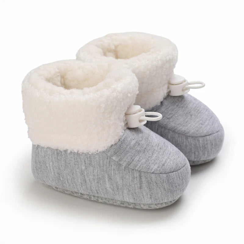 Gray baby winter boots with a heathered finish, fluffy white cuffs, and white toggles