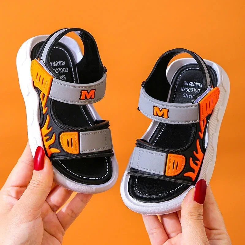 Gray and black sandals with orange flame graphics and strap accents