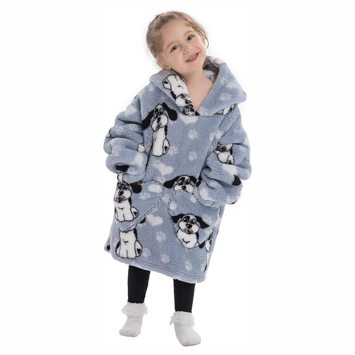 Child wearing a gray dog-print hooded blanket with hands in the front pockets