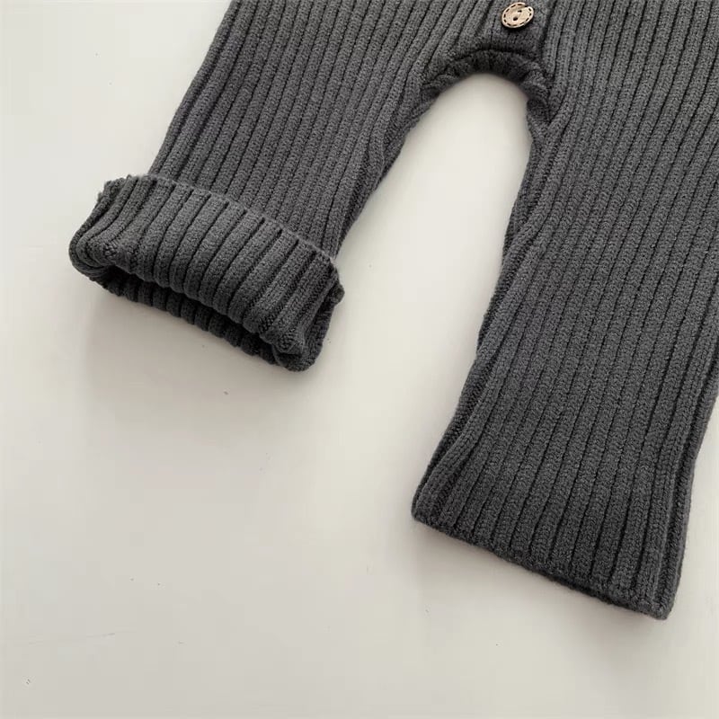 Gray knitted romper legs showing ribbed texture and a folded ankle cuff