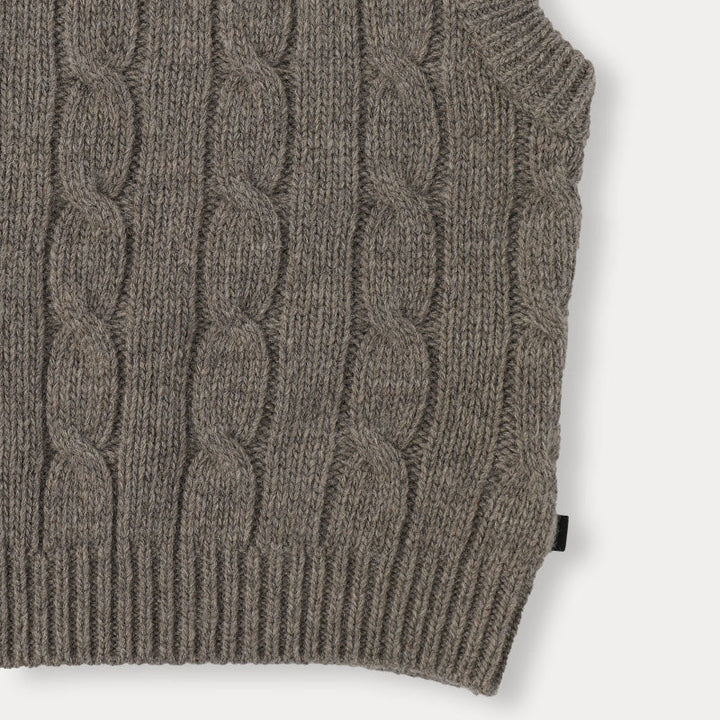 Detail of a gray cable-knit vest&