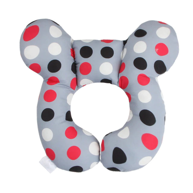 Gray contoured pillow with red, white, and black polka dots