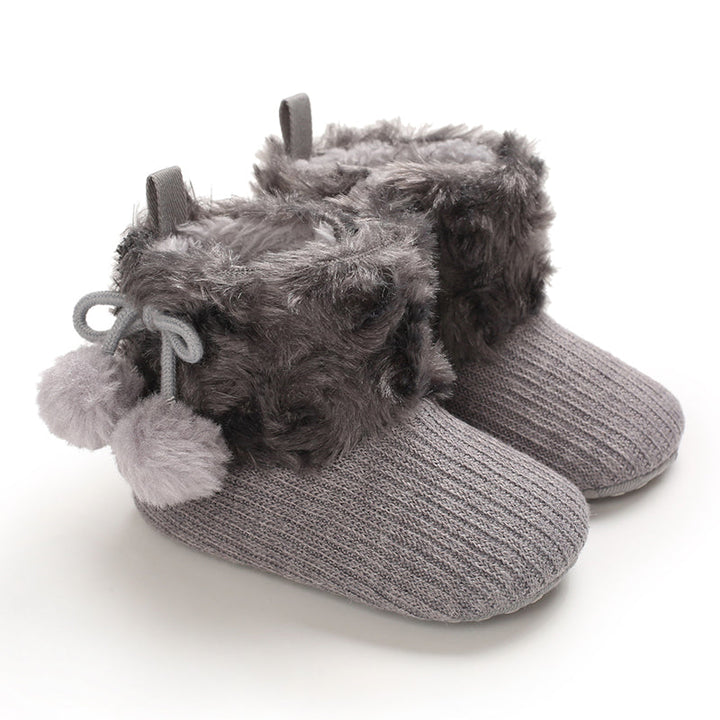 Gray baby boots with fluffy cuffs and tied pom-pom accents
