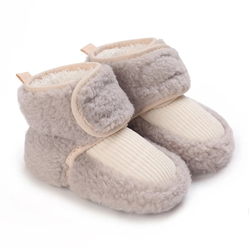 Gray baby shoes with cream ribbed front panels and plush cuffs.