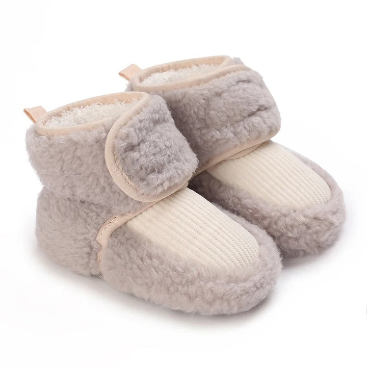 Gray baby shoes with cream ribbed front panels and plush cuffs.