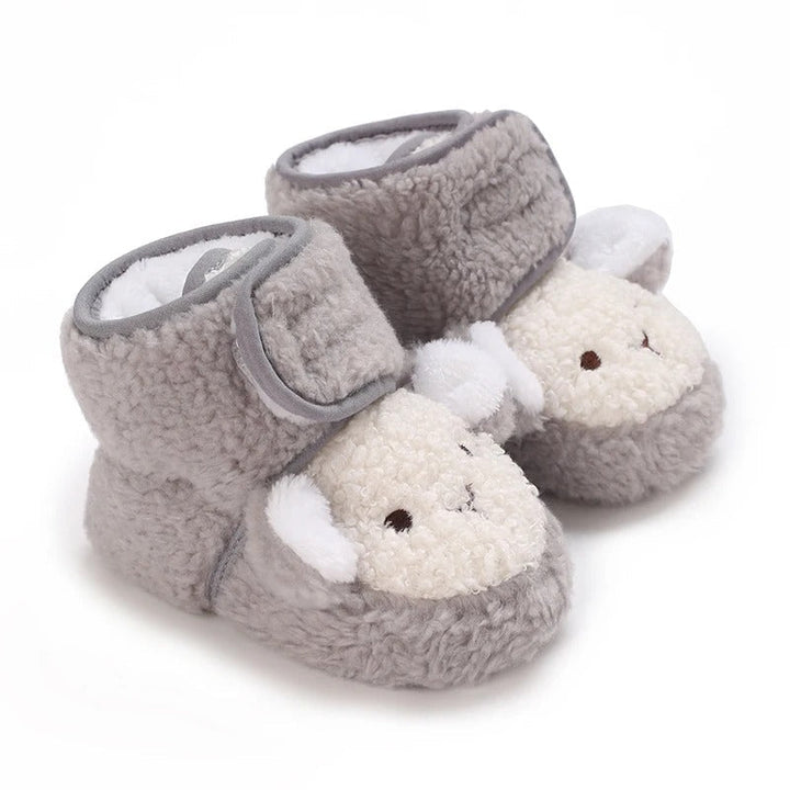 Gray baby shoes with fluffy sheep faces and wraparound ankle straps.