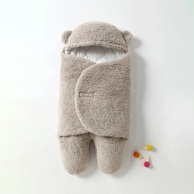 Gray sherpa baby wrap blanket with a bear-ear hood and two enclosed foot sections.