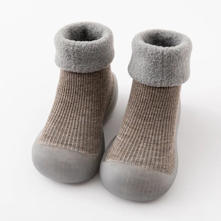Dark gray sock shoes with lighter gray folded cuffs and rounded rubber toes.