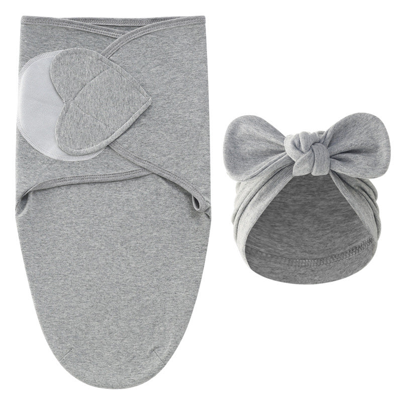 Gray swaddle blanket with overlapping panels and a matching gray bow hat