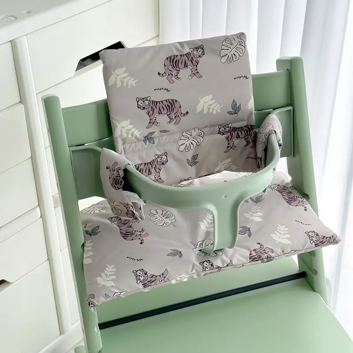 Gray tiger-and-leaf seat and back cushions fitted to a mint-green high chair