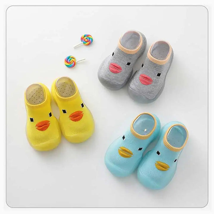 Gray, yellow, and light blue duck-face sock shoes arranged in pairs