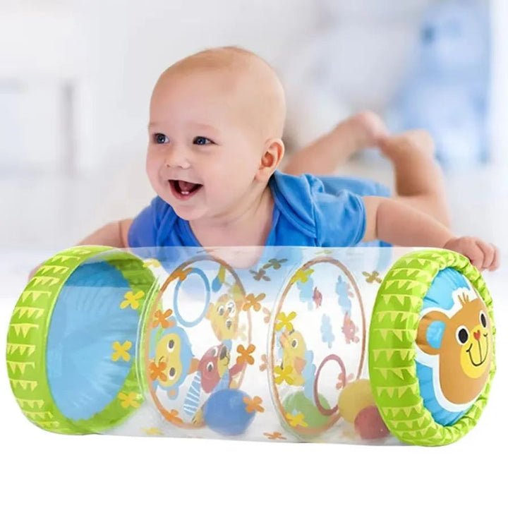 Baby lying on their tummy with a green inflatable animal-print activity roller