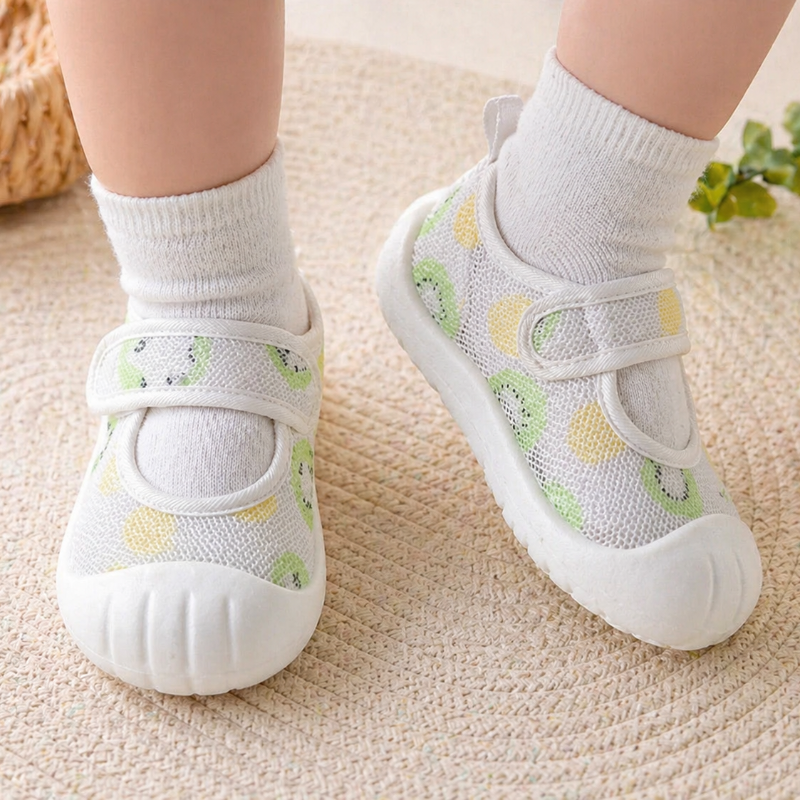 Green and yellow patterned strap shoes worn over white socks.