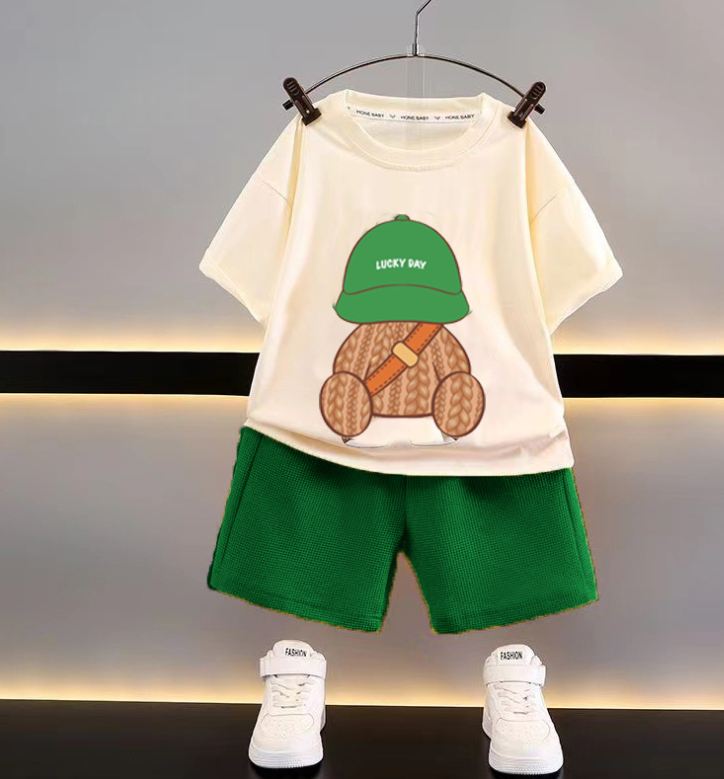 Cream T-shirt printed with a teddy bear in a green cap, paired with green shorts