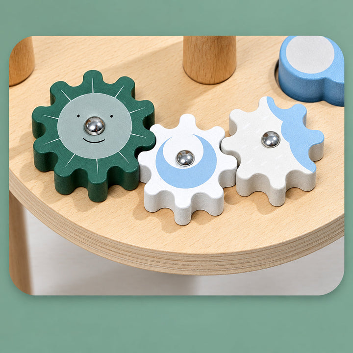 Green, white, and pale blue interlocking gears on the wooden activity tabletop