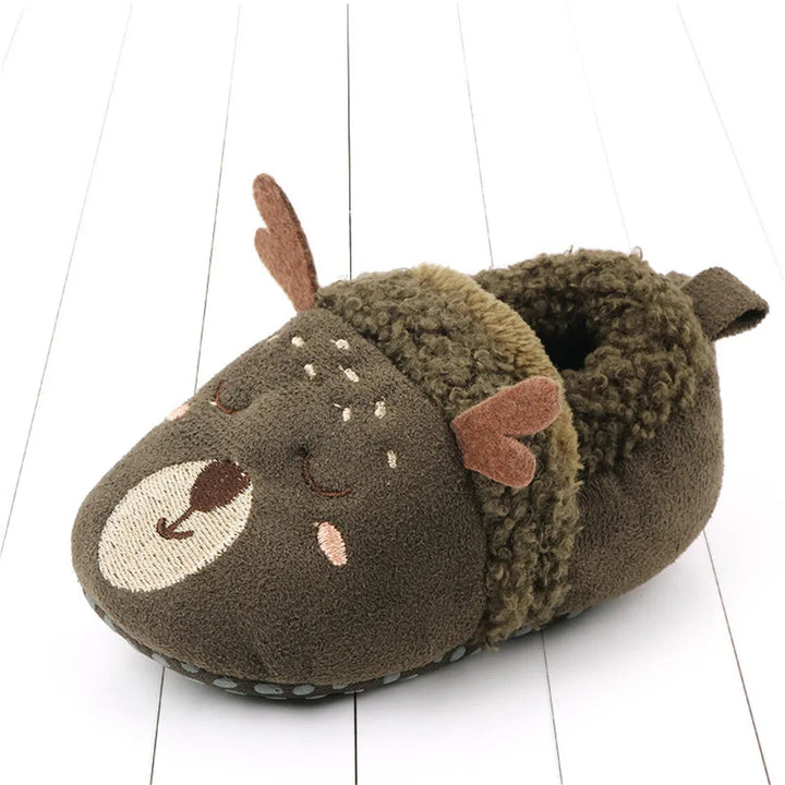 Green deer baby slipper with antlers, a sleepy face, and a fuzzy cuff.