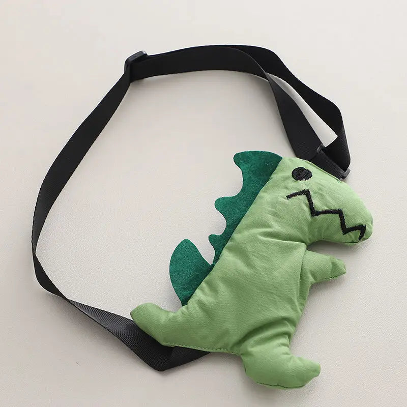 Green dinosaur toy with dark green back spikes and a black strap