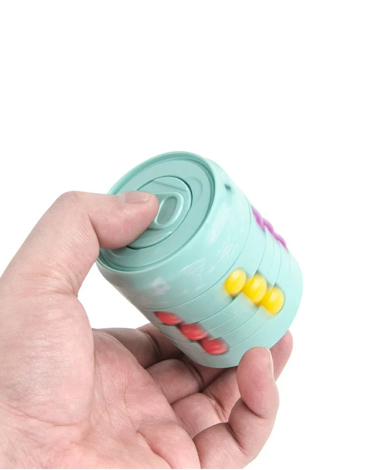 Green fidget puzzle held in one hand, showing rotating rings and colored beads