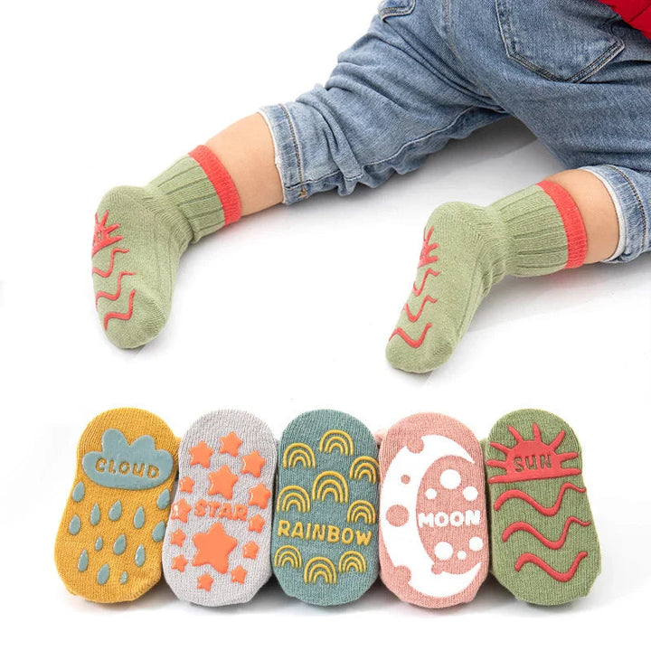 Child wearing green grip socks, with five colorful patterned soles displayed below