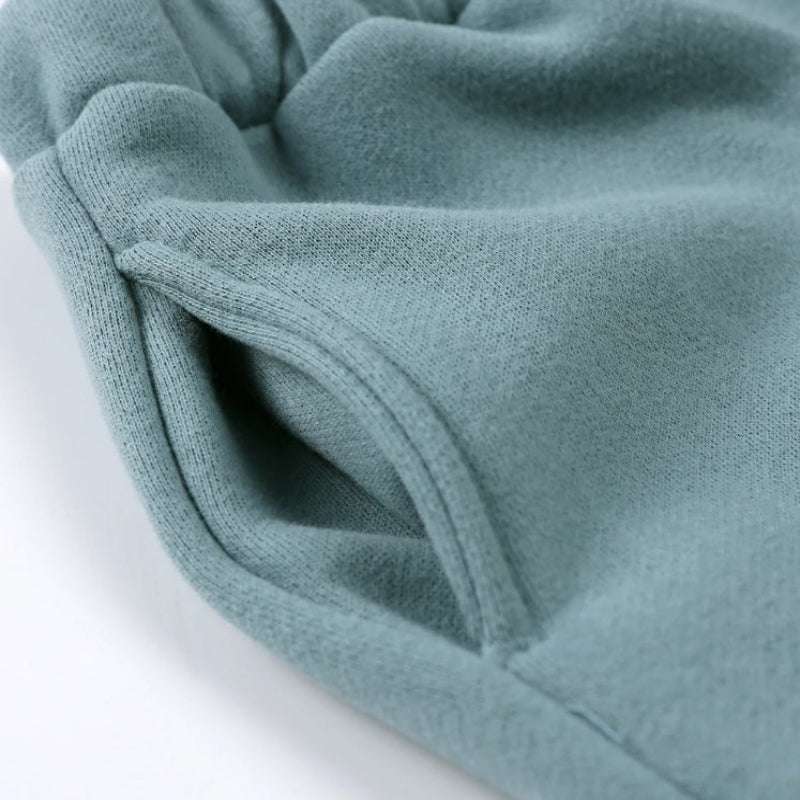 Side pocket and stitching detail on green jogger pants