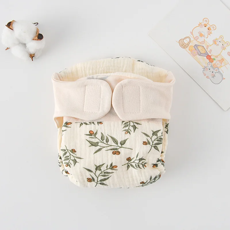 Cloth diaper with green leafy branches and small floral details