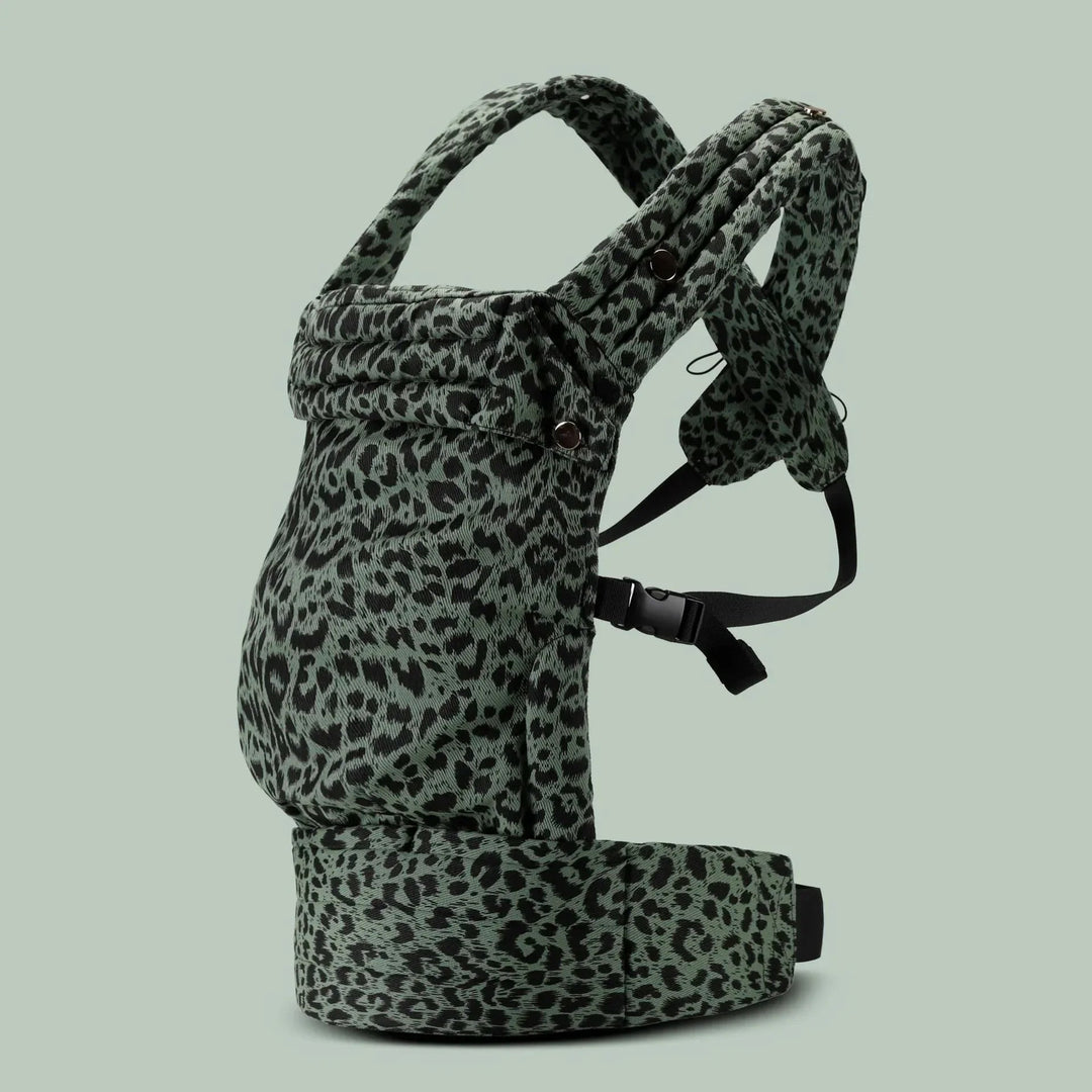 Green leopard-print baby carrier with black fastening straps and a padded waist belt