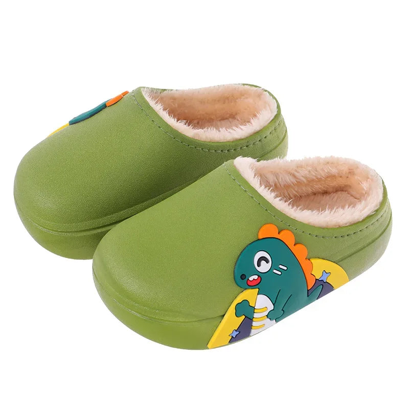 Green dinosaur slippers with beige lining against a white background