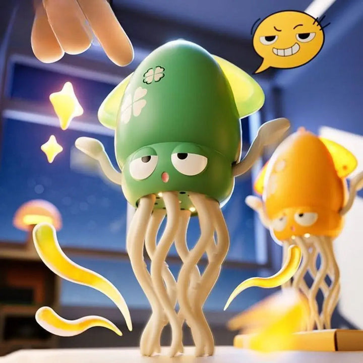 Hand touching the top of a green octopus toy, with a yellow toy behind it