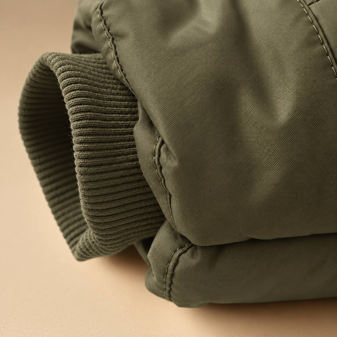 Ribbed knit cuff extending from the padded sleeve of a green kids&