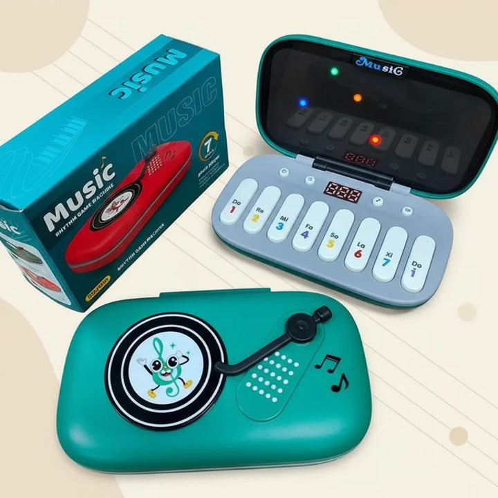 Green piano toy shown open and closed beside its retail box