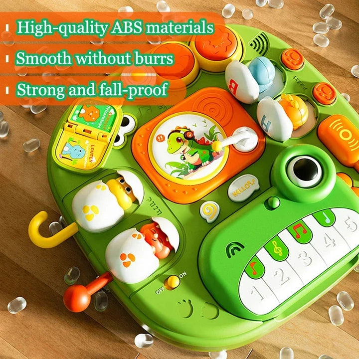 Close-up of the green activity surface with drum pads, sliders, and a frog-shaped piano